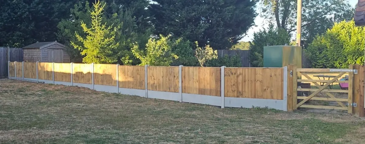 After: new closeboard fence on concrete posts and gravel boards with a timber field gate